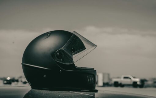 Matte black motorcycle helmet resting on a flat surface against a soft neutral background