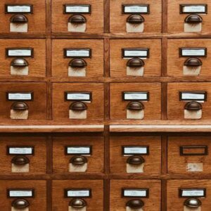 A wall of small labelled wooden card-catalogue drawers