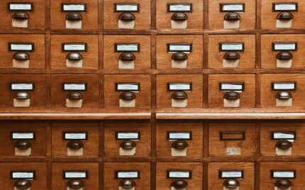 A wall of small labelled wooden card-catalogue drawers