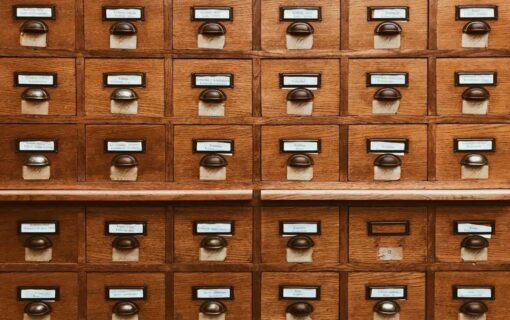 A wall of small labelled wooden card-catalogue drawers