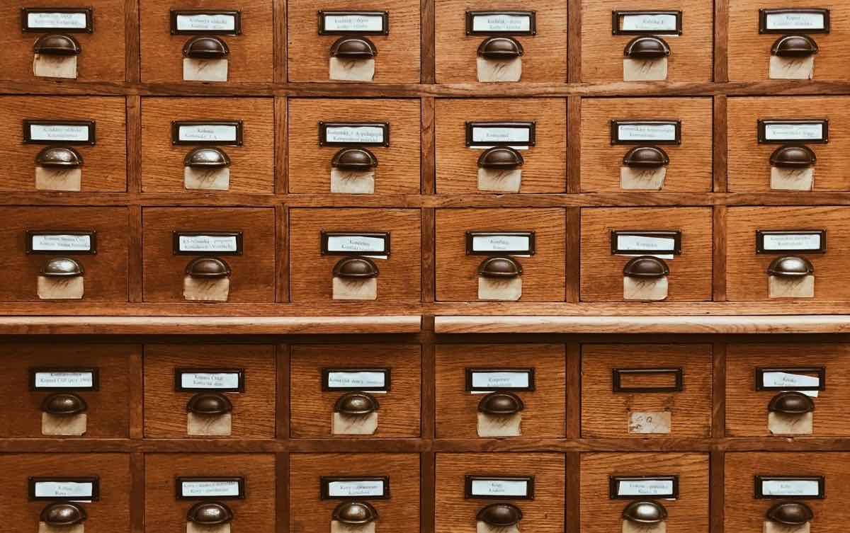 A wall of small labelled wooden card-catalogue drawers