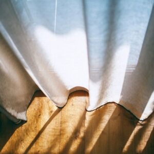 Sheer curtain moving in warm afternoon light