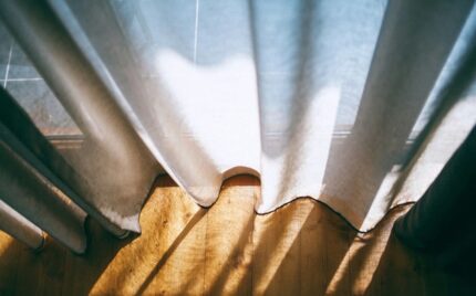 Sheer curtain moving in warm afternoon light