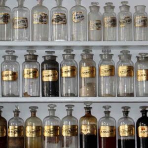 Shelves of apothecary jars with gold ingredient labels