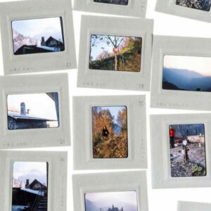 Framed photographic slides spread out on a white surface