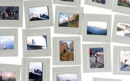 Framed photographic slides spread out on a white surface
