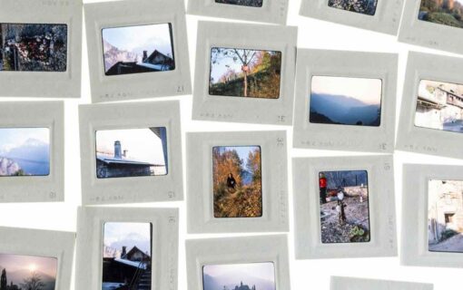 Framed photographic slides spread out on a white surface