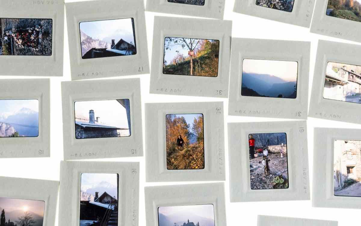 Framed photographic slides spread out on a white surface